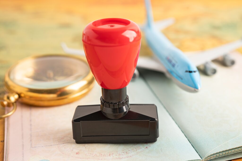 Approved Stamp visa and passport document to immigration at airport in country.